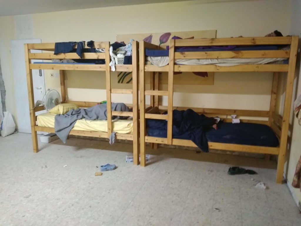 Three boys sleeping in their relocated bunks