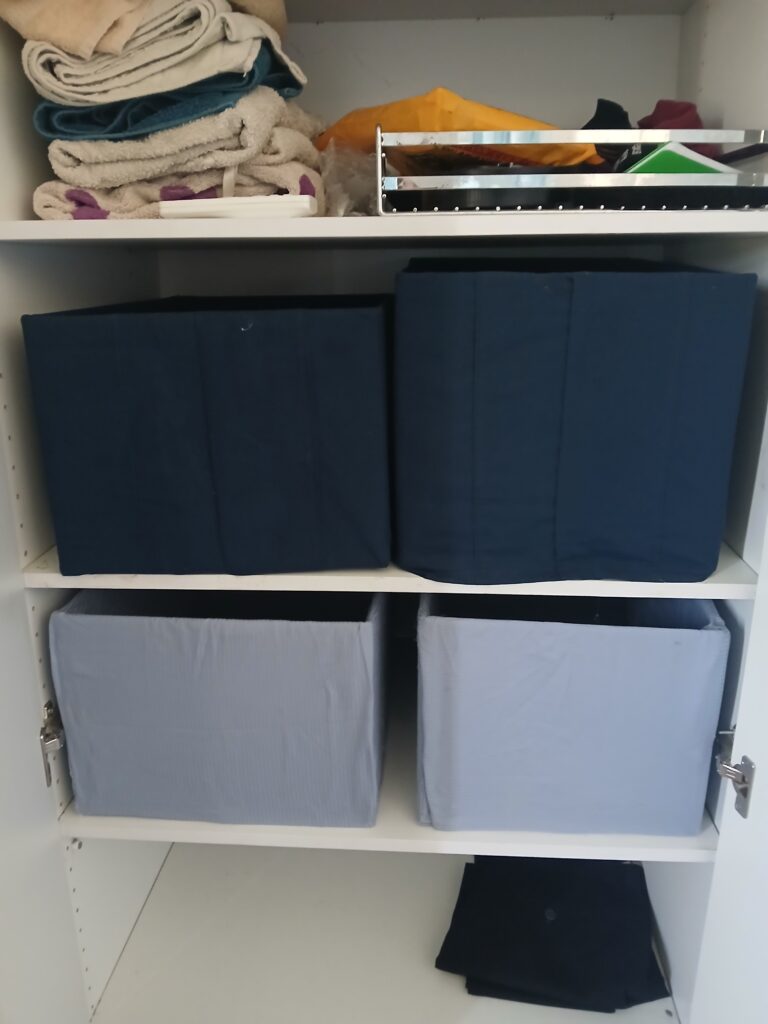 Here's what the storage boxes I made look like - nothing fancy, but more visually appealing than a plain cardboard box. 
